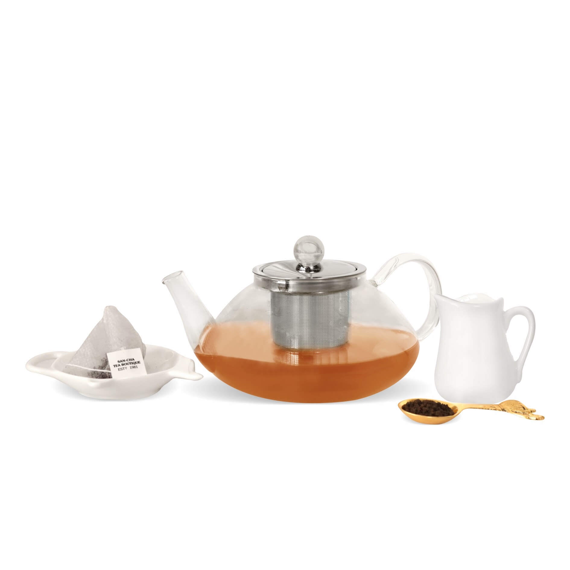 Tea set with teapot, cup, and accessories on a white background