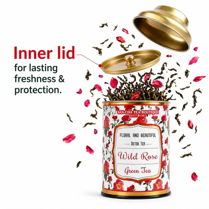 Tea canister with floral design and 'Wild Rose Green Tea' label, gold inner lid shown open.
