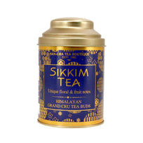 Sikkim tea canister with blue and gold label on a white background